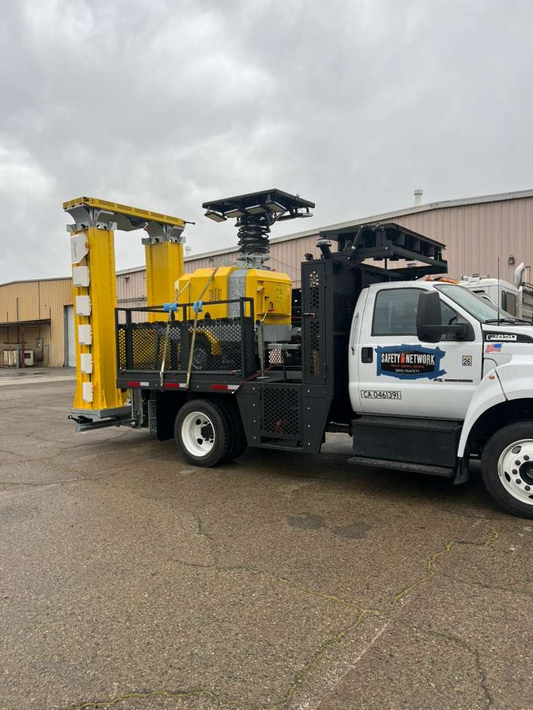 Traffic safety truck with rear-mounted attenuator and work-zone storage